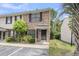 Charming brick townhome featuring black shutters, a covered entrance, and well-maintained landscaping at 6260 Brandt St # 4-D, North Charleston, SC 29406