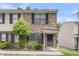 Charming brick townhome featuring black shutters, a covered entrance, and well-maintained landscaping at 6260 Brandt St # 4-D, North Charleston, SC 29406