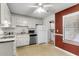 This kitchen features white cabinets and appliances with a window providing natural light, creating an efficient cooking space at 6260 Brandt St # 4-D, North Charleston, SC 29406