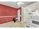 An efficient kitchen with classic white appliances is complemented by white cabinetry and features views into other living spaces at 6260 Brandt St # 4-D, North Charleston, SC 29406