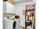 A functional laundry room with appliances and storage space is organized with shelving for cleaning supplies and tools at 6260 Brandt St # 4-D, North Charleston, SC 29406