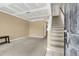 Living room with carpet, stairway, neutral walls, and a door leading to other rooms at 6260 Brandt St # 4-D, North Charleston, SC 29406