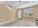 A living room with neutral walls, large window for light, and stairway offers a blank canvas ready for personalization at 6260 Brandt St # 4-D, North Charleston, SC 29406