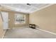 A spacious living room features a window with blinds, beige walls, and carpeted floors, awaiting personalization at 6260 Brandt St # 4-D, North Charleston, SC 29406