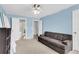 Living room featuring couch, neutral carpet, and doorways to bathroom and kitchen at 6260 Brandt St # 4-D, North Charleston, SC 29406