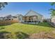 Spacious backyard with a covered patio and well-maintained lawn, ideal for outdoor activities at 632 Grassy Hill Rd, Summerville, SC 29483