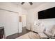 Bedroom featuring white furniture, hardwood floors, a large television, and a ceiling fan at 632 Grassy Hill Rd, Summerville, SC 29483