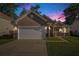 Charming home with a two-car garage, manicured lawn, stone accents, and a welcoming front porch at 632 Grassy Hill Rd, Summerville, SC 29483