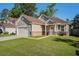 Beautiful home featuring stone accents, a two-car garage, and a well-maintained lawn on a sunny day at 632 Grassy Hill Rd, Summerville, SC 29483