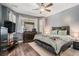 Spacious main bedroom with hardwood floors, natural light, modern furnishings, and gray painted walls at 632 Grassy Hill Rd, Summerville, SC 29483