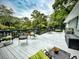 Inviting back deck features ample seating and offers a serene outdoor retreat with a picturesque backyard view at 717 Chatter Rd, Mount Pleasant, SC 29464