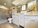 A modern bathroom features double sink vanities and a walk-in shower with glass door at 717 Chatter Rd, Mount Pleasant, SC 29464
