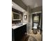 Charming bathroom features a dark vanity with a marble countertop, and vintage-style mirror at 717 Chatter Rd, Mount Pleasant, SC 29464