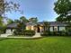Charming single-story home featuring a well-manicured lawn and mature landscaping, bathed in the soft light of dusk at 717 Chatter Rd, Mount Pleasant, SC 29464