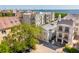 Aerial view featuring rooftops, lush trees, and the waterfront in the background at 8 Prioleau St # Th A, Charleston, SC 29401