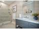 Bathroom featuring a glass-enclosed shower, gray vanity with marble top, and framed mirror at 8 Prioleau St # Th A, Charleston, SC 29401