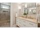 Bathroom featuring double vanity sinks, decorative mirror, and a walk in shower at 8 Prioleau St # Th A, Charleston, SC 29401