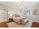 Bright bedroom featuring a bed, crystal chandelier, hardwood floors, and plenty of natural light at 8 Prioleau St # Th A, Charleston, SC 29401
