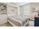 Bright bedroom featuring a built-in Murphy bed, white shutters and bench seating near the window at 8 Prioleau St # Th A, Charleston, SC 29401
