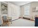 Bright bedroom with a built-in Murphy bed system and bench seating near a window with white shutters at 8 Prioleau St # Th A, Charleston, SC 29401