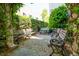 Inviting courtyard with brick-paved patio surrounded by lush greenery and multiple benches at 8 Prioleau St # Th A, Charleston, SC 29401