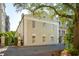 Stately Charleston home featuring classic architecture, a manicured street view, and beautiful tree canopy at 8 Prioleau St # Th A, Charleston, SC 29401