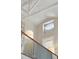 Bright foyer features a staircase with white railings, an oval window and decorative light fixtures at 8 Prioleau St # Th A, Charleston, SC 29401