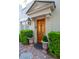 Elegant front entrance with wooden door, charming potted plants, and brick walkway at 8 Prioleau St # Th A, Charleston, SC 29401