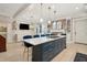 Open-concept kitchen with island seating, white cabinets, and access to other living spaces at 8 Prioleau St # Th A, Charleston, SC 29401