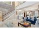 Expansive living area with a brick wall, staircase, and cozy seating arrangement at 8 Prioleau St # Th A, Charleston, SC 29401