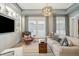 Bright living room featuring a large sofa, stylish decor, and a stunning light fixture at 8 Prioleau St # Th A, Charleston, SC 29401