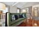 Living room showcases a stylish green sofa, exposed brick walls and gleaming wood floors at 8 Prioleau St # Th A, Charleston, SC 29401