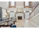 Bright living room features a fireplace, detailed millwork, and staircase with an open floor plan at 8 Prioleau St # Th A, Charleston, SC 29401