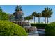 The iconic Pineapple Fountain surrounded by lush greenery and palm trees under a clear blue sky at 8 Prioleau St # Th A, Charleston, SC 29401