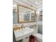 Elegant powder room with a pedestal sink, decorative mirror, and stylish wall sconces at 8 Prioleau St # Th A, Charleston, SC 29401