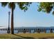 Scenic waterfront view featuring a park bench, palm tree, and sailboats on the water at 8 Prioleau St # Th A, Charleston, SC 29401