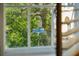 View from a window overlooking lush greenery and Prioleau Street sign in the French Quarter at 8 Prioleau St # Th A, Charleston, SC 29401
