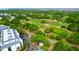 Aerial view of a golf course surrounded by a community with lush green trees and gardens at 8000 Palmetto Dr # 104-A, Isle of Palms, SC 29451