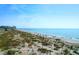 Wide beach with a condo building on the left, ocean view, and people enjoying the sunny weather at 8000 Palmetto Dr # 104-A, Isle of Palms, SC 29451