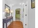 Welcoming hallway featuring hardwood floors, a console table, and a view into another room at 8000 Palmetto Dr # 104-A, Isle of Palms, SC 29451