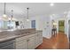 Modern kitchen with granite countertops, stainless steel appliances, and an open view of the living room at 8000 Palmetto Dr # 104-A, Isle of Palms, SC 29451