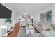 Open living area featuring comfortable sofas and a view into the kitchen area with modern appliances at 8000 Palmetto Dr # 104-A, Isle of Palms, SC 29451