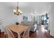 Open concept dining and living space with comfortable sofas and a dining table near the window at 8000 Palmetto Dr # 104-A, Isle of Palms, SC 29451