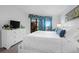 Relaxing main bedroom features a bright window view and white, neutral paint at 8000 Palmetto Dr # 104-A, Isle of Palms, SC 29451