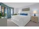 Bright main bedroom features a balcony, beach-themed decor, and light, neutral paint at 8000 Palmetto Dr # 104-A, Isle of Palms, SC 29451