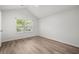 Cozy bedroom with vaulted ceiling, a large window, ceiling fan, and Luxury Vinyl Plank flooring at 8624 Grassy Oak Trl, North Charleston, SC 29420
