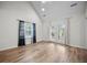 Bright bedroom features wood-look floors, vaulted ceiling, and ample natural light from the windows and glass paneled door at 8624 Grassy Oak Trl, North Charleston, SC 29420