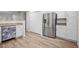 Modern kitchen features stainless steel refrigerator, decorative dishwasher, white cabinets, and granite countertops at 8624 Grassy Oak Trl, North Charleston, SC 29420
