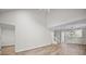 Open and airy living space with wood-look flooring, vaulted ceiling and a view into the dining area and kitchen at 8624 Grassy Oak Trl, North Charleston, SC 29420