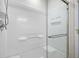 Modern bathroom shower featuring white tile and a frameless glass door at 8624 Grassy Oak Trl, North Charleston, SC 29420